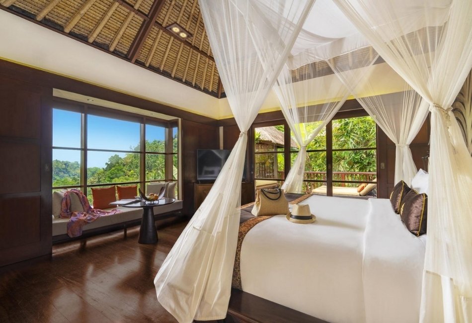 Luxury villa bedroom with canopy bed and tropical views in Indonesia