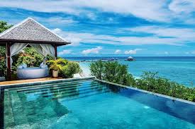 Exclusive Wakatobi Dive Resort bungalows nestled between white sand and crystal-clear turquoise waters