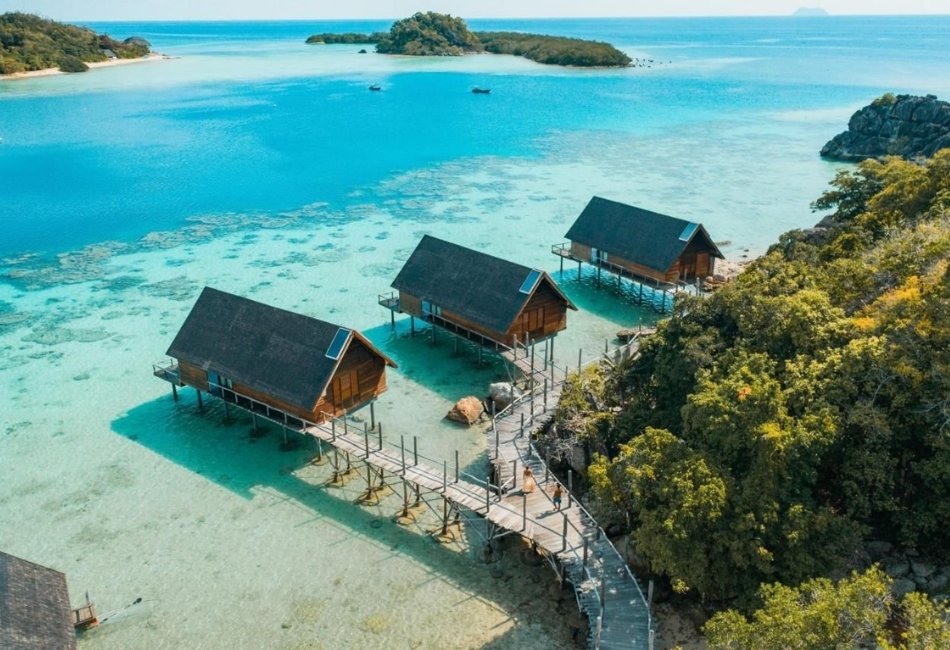 Overwater bungalows on a tropical island for a friends vacation in Indonesia