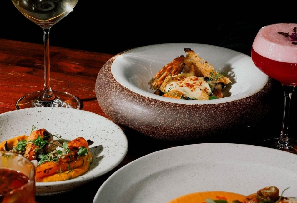 Fine dining dishes with wine and cocktails at a luxury restaurant in Bali