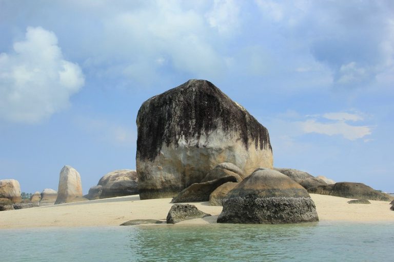 Sailing Rock Island (Pulau Batu Berlayar) near Tanjung Kelayang Beach, Belitung — iconic granite formations rising from turquoise sea on island-hopping tour