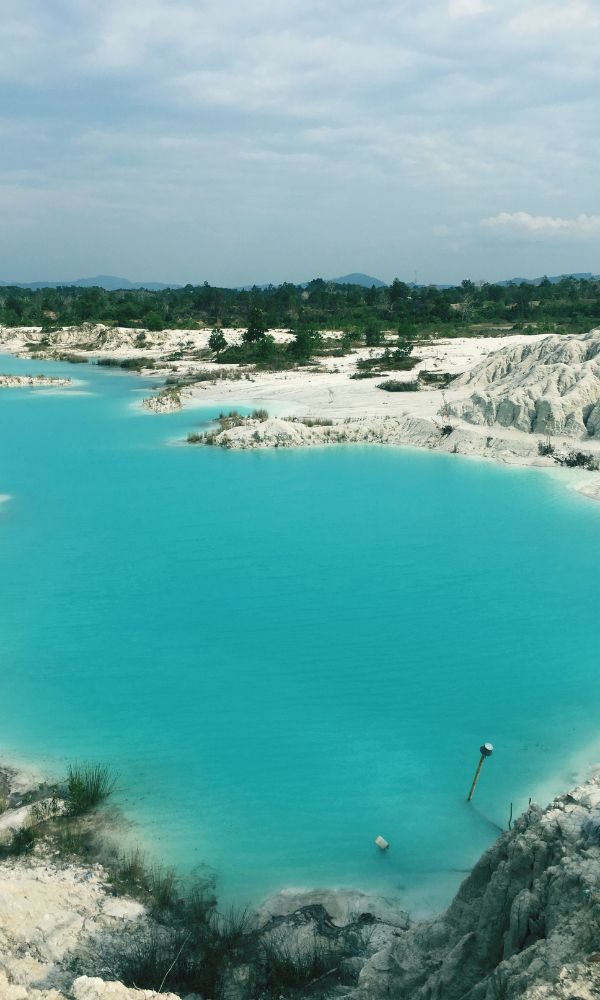 Turquoise Kaolin Lake in Belitung Island surrounded by white clay hills — geological attraction and part of Belitung Geopark