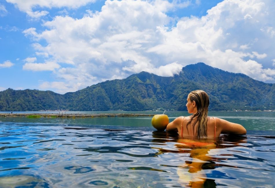 Happy woman relaxing in Batur natural hot spring spa